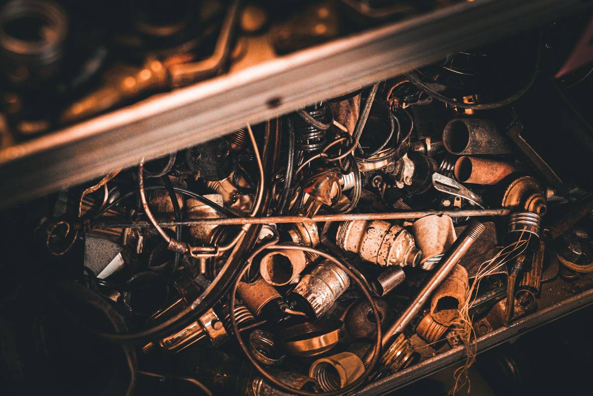Infographic showing common household sources of scrap gold: jewelry, dental crowns, electronics, eyeglasses, and industrial connectors