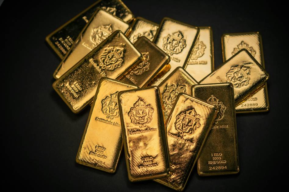 Scrap gold jewelry and coins on a weighing scale